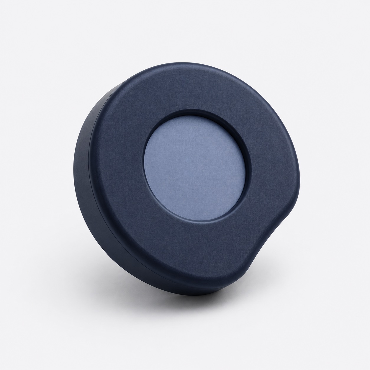 ORA, a round midnight-blue puck with a recessed center and a soft notch